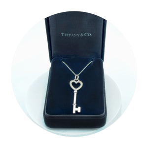 Estate 18K White Gold Tiffany & Co. Heart Key Pendant on a chain (0.08CTW)